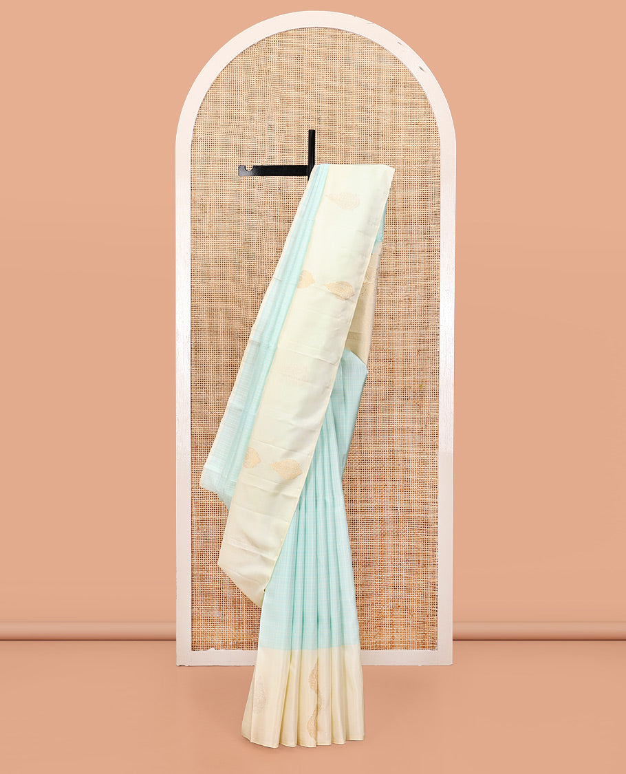 Pale Blue Kanchipuram Silk Saree, Sparsely Woven with Checks, Complemented by a Contrast Zari Buttas Woven Border, Jaal Pallu, and Contrast Blouse