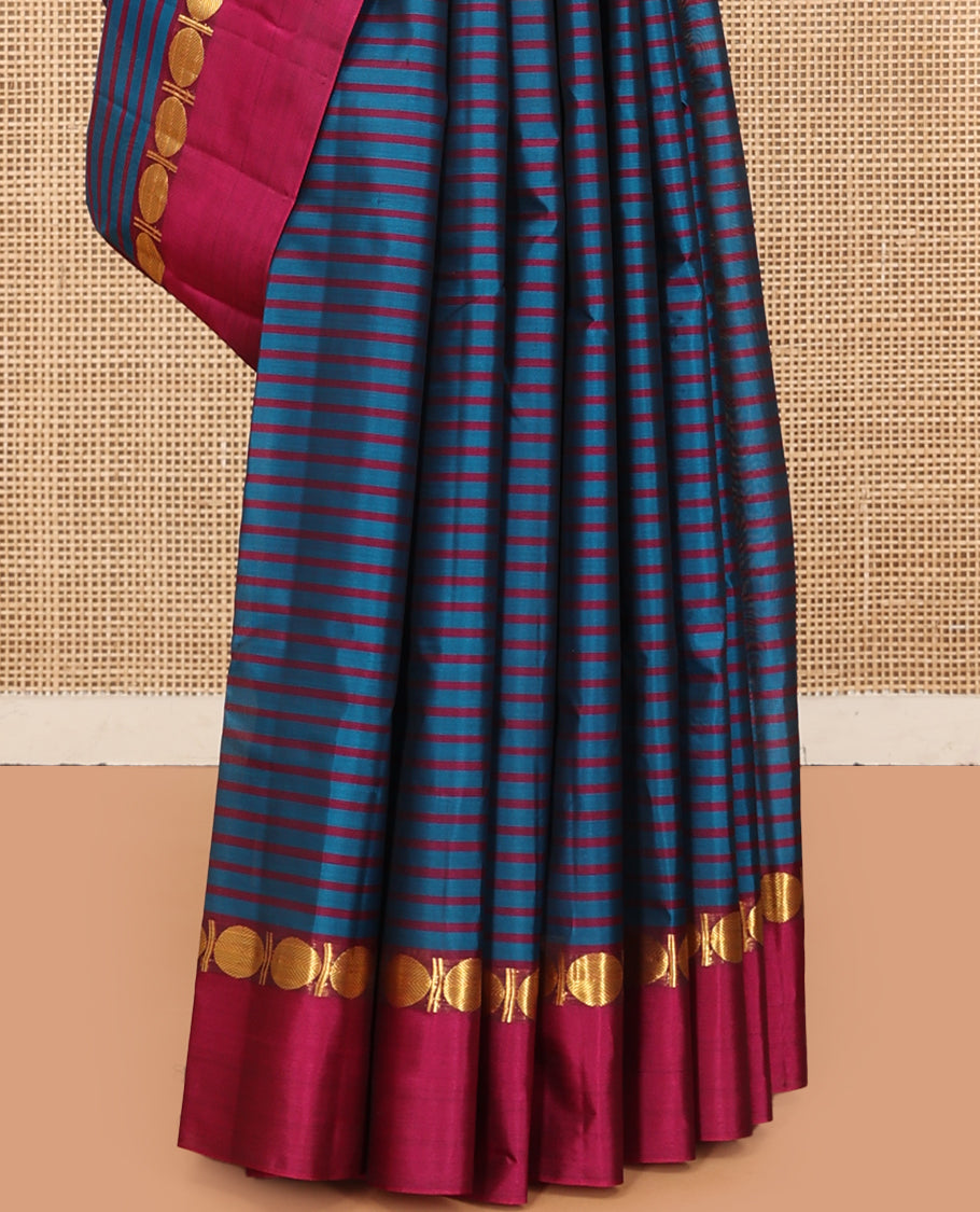 Blue Striped Kanchipuram Silk Saree, Complemented by a Contrast Kal Eragina Border of Rudraskham Design, Pallu of Zari Design, and a Contrast Blouse