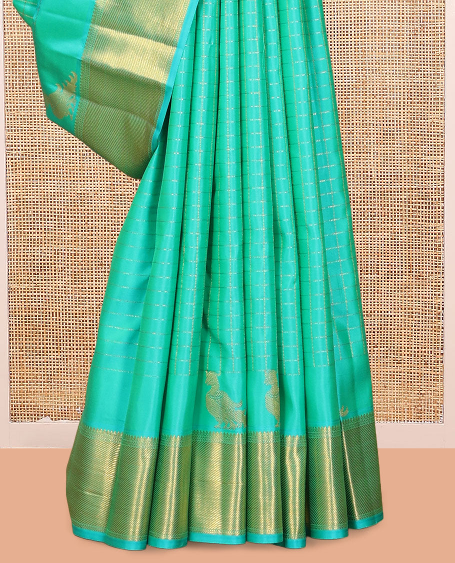 Turquoise Kanchipuram Silk Saree, Detailed with Zari Checks, and Mayil Buttas, a Zari Border of Thilakam Mokku, Kathir, and Zari Stripes, Zari Striped Pallu, and a Matching Blouse