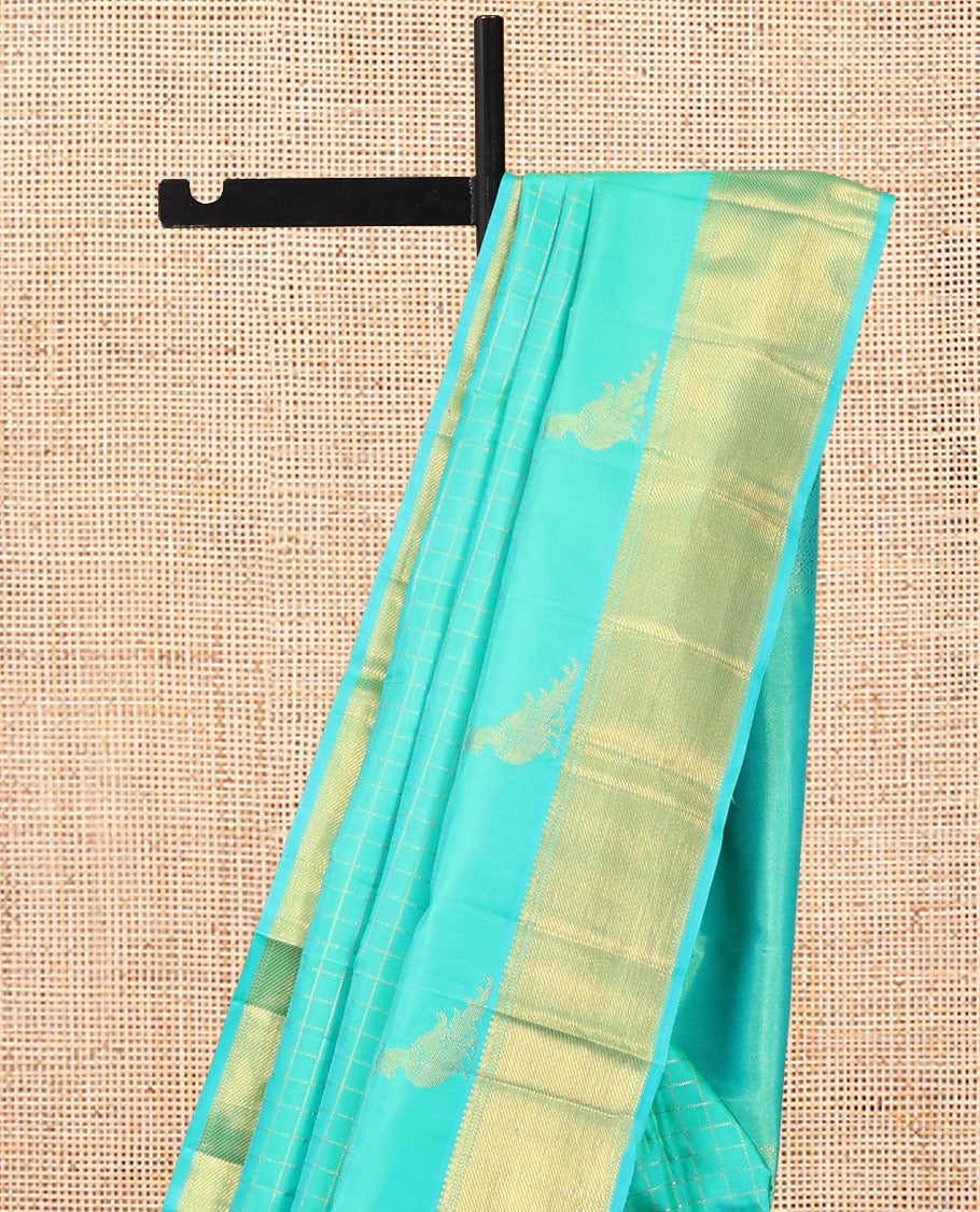 Turquoise Kanchipuram Silk Saree, Detailed with Zari Checks, and Mayil Buttas, a Zari Border of Thilakam Mokku, Kathir, and Zari Stripes, Zari Striped Pallu, and a Matching Blouse