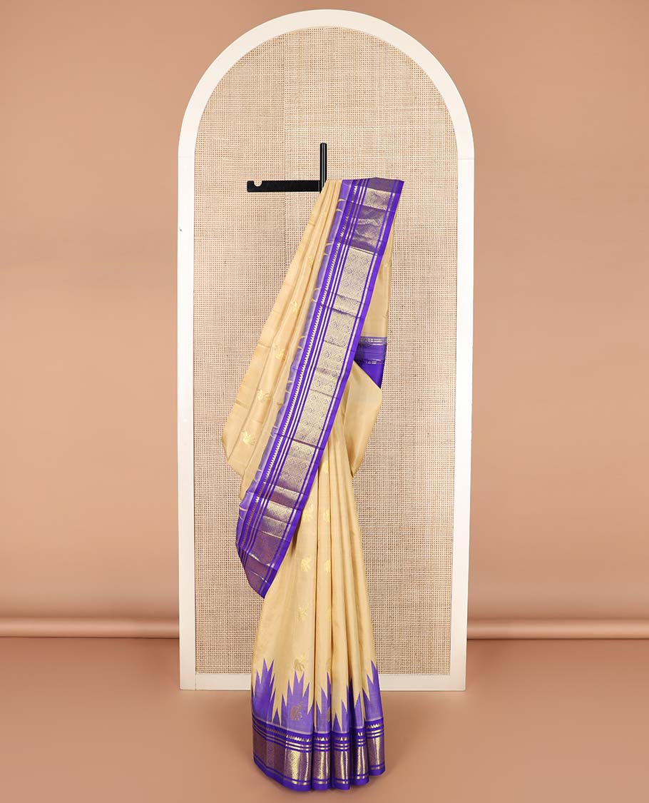 Light sandal yaanai buttas Kanchipuram silk saree, contrast one-sided thazampoo rekku border of thilakam mokku, banaras, and jaal designs, and floral jaal pallu