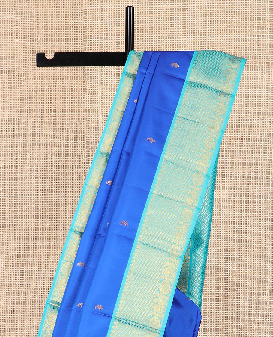 Blue vanki manga buttas Kanchipuram silk saree, contrast korvai border of salngai, banaras, ara maadam, and anna chakram designs, and jaal pallu