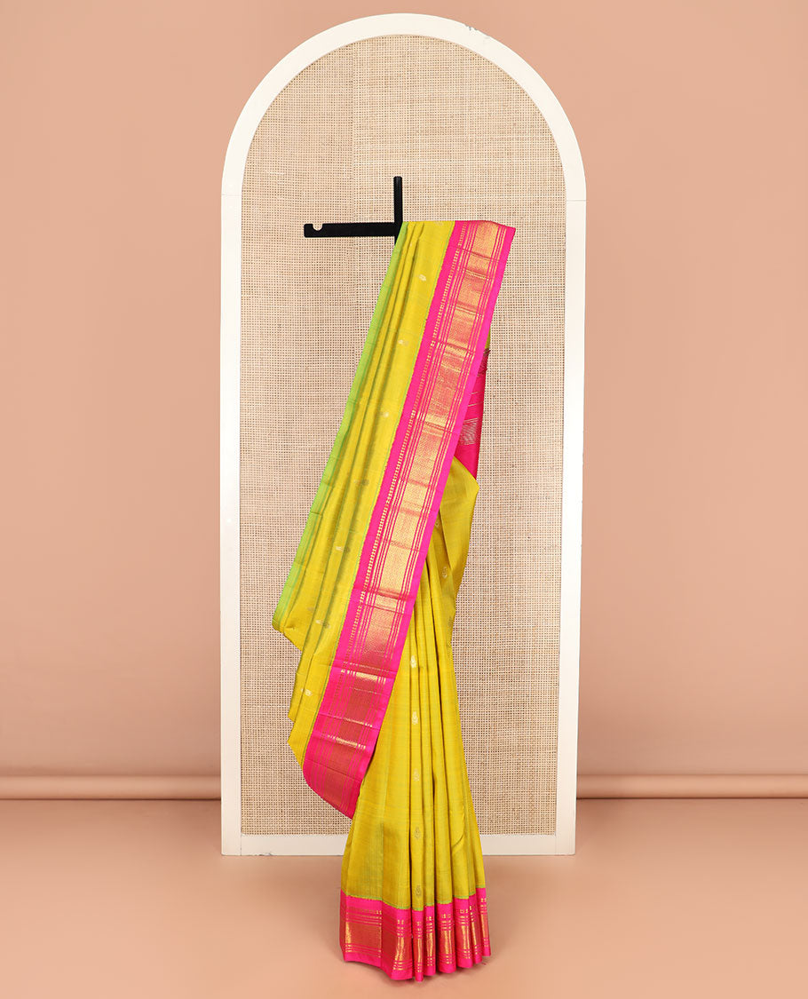 Green Kanchipuram Silk Saree Sparsely Sparkled with Zari Buttas All Over Its Body, Complemented by Contrast One-Sided Korvai Border of Paneer Sombu, Banaras, Muthu, and Mayil Kann Designs, Pallu of Zari Designs, and Comes Without a Blouse