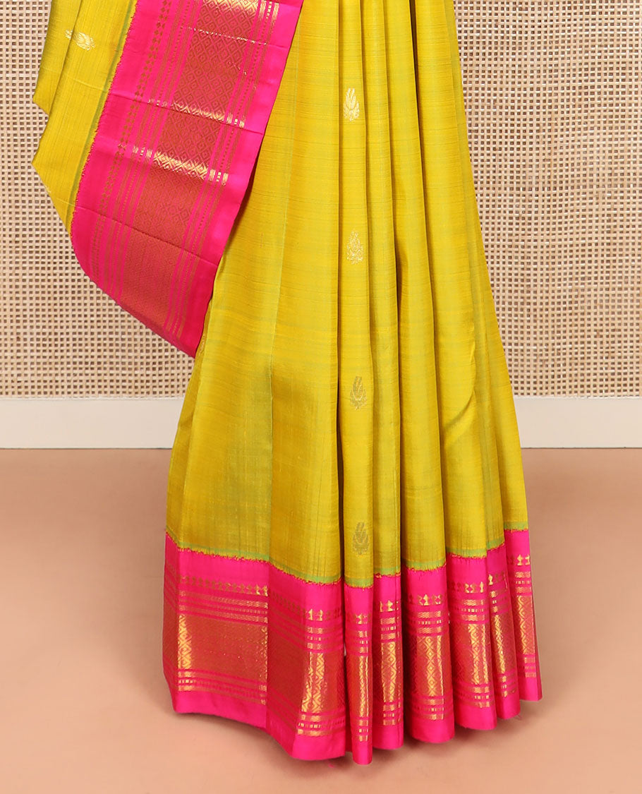 Green Kanchipuram Silk Saree Sparsely Sparkled with Zari Buttas All Over Its Body, Complemented by Contrast One-Sided Korvai Border of Paneer Sombu, Banaras, Muthu, and Mayil Kann Designs, Pallu of Zari Designs, and Comes Without a Blouse