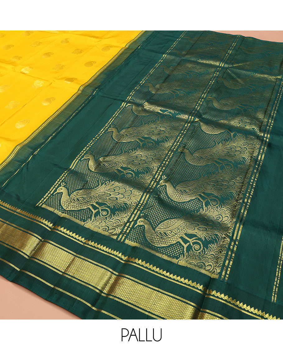 Yellow Kanchipuram Silk Saree, Adorned with Manga and Mayil Buttas, Complemented by Contrast One-Sided Korvai Border of Thilakam Mokku, Banaras, and Kuyil Kann Designs, Pallu Steeped with Mayil Designs, and Comes Without a Blouse