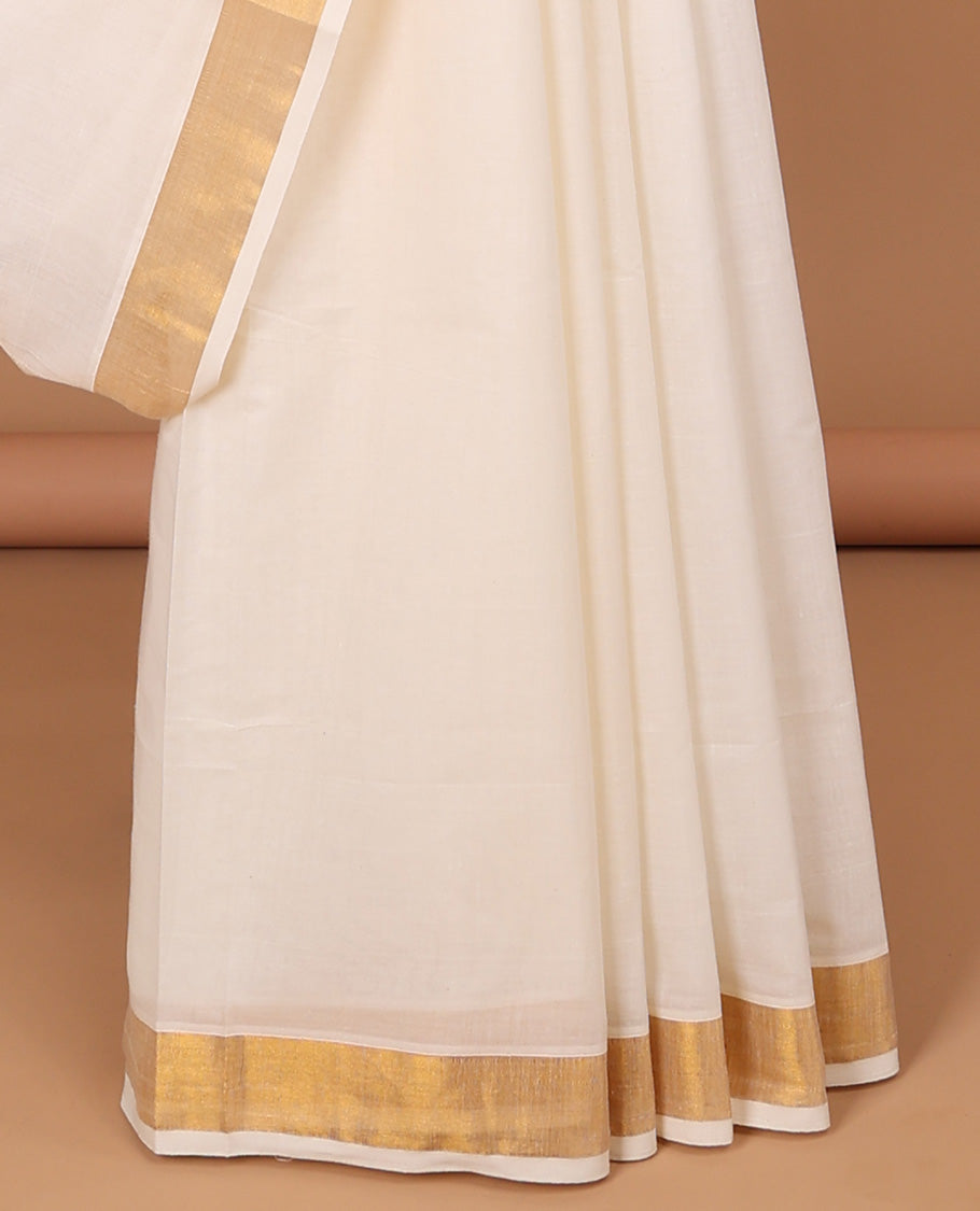 Cream kerala saree with zari stripes, zari border & pallu of floral designs