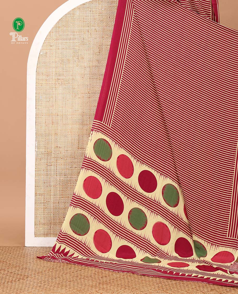Magenta vertical stripes printed modal satin saree, a self-border of horizontal stripes print, polka dots printed on the pallu, and an intricate ajrakh-style printed blouse
