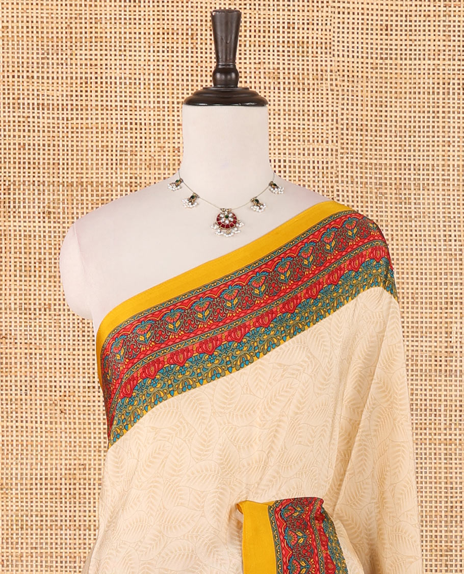 Cream leaf motifs printed crepe silk saree, contrast yellow printed blouse, kaleidoscope coloured intricately printed border & pallu