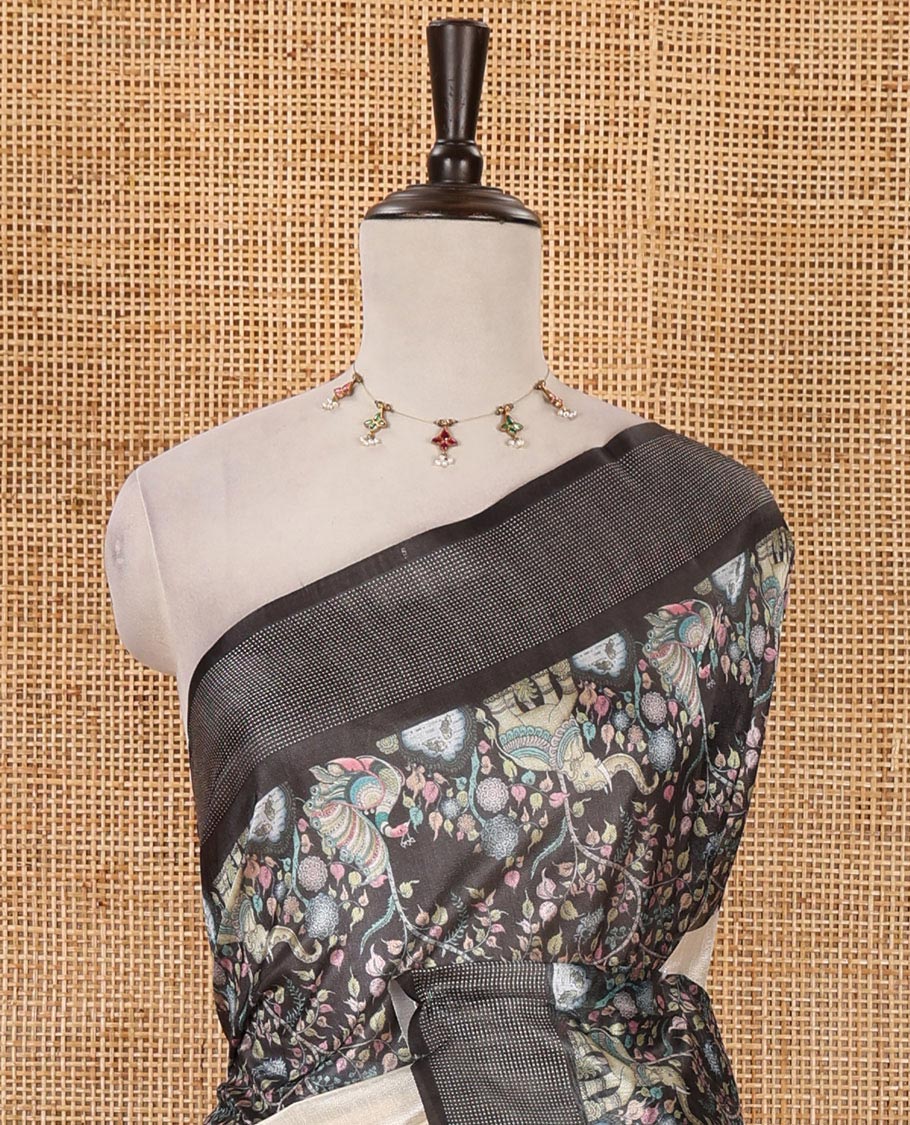Cream plain tissue saree, contrast dobby-style zari buttas & kalamkari-style flora-fauna printed border & pallu