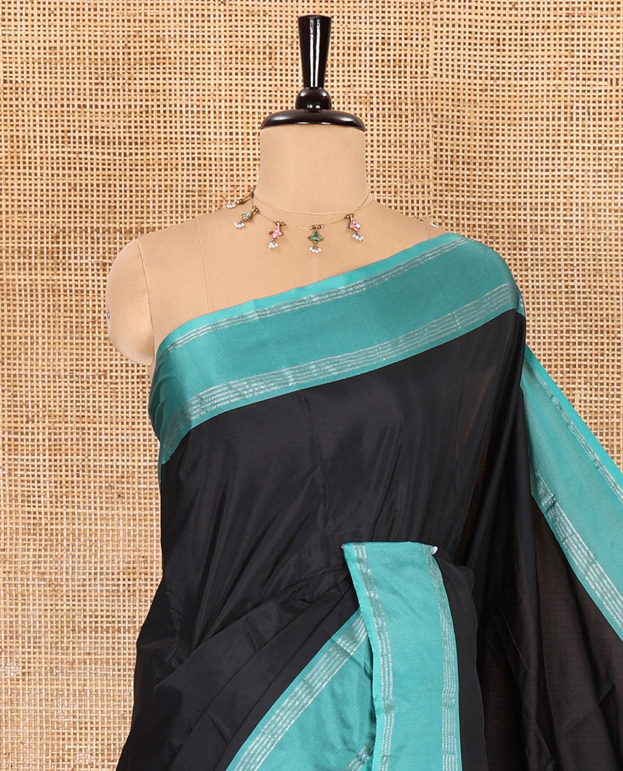 Black plain semi-soft silk saree, contrast horizontal zari striped border, striped pallu, and a matching blouse