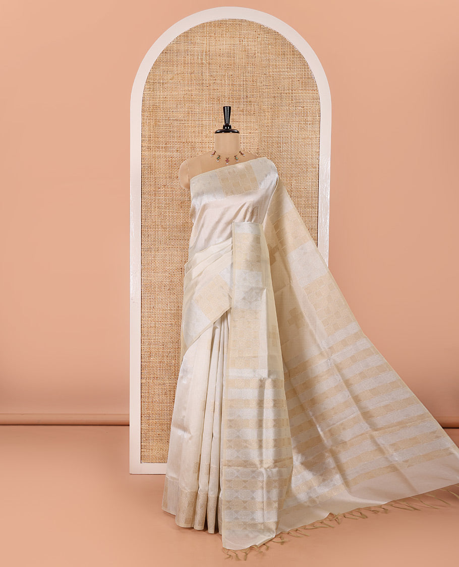 Cream Semi Tussar Saree Elevated with Zari Plus-Shaped Buttas, Gleaming Border of Intricate Zari Checks, Pallu Richly Woven with Jaal Designs, and Paired with a Matching Blouse