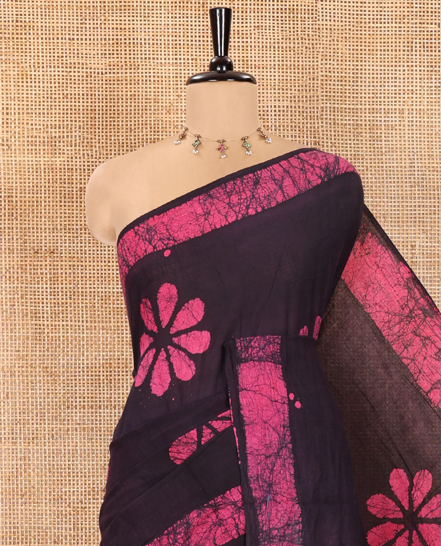Wine Mul Cotton Saree Detailed with Batik-Style Floral Motifs Printed All Over Its Body, Complemented by a Contrast Batik Printed Border, Pallu Mirrors the Same Batik Print, and Is Paired with a Matching Blouse