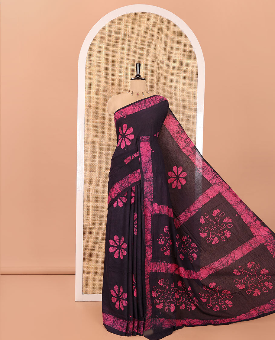 Wine Mul Cotton Saree Detailed with Batik-Style Floral Motifs Printed All Over Its Body, Complemented by a Contrast Batik Printed Border, Pallu Mirrors the Same Batik Print, and Is Paired with a Matching Blouse