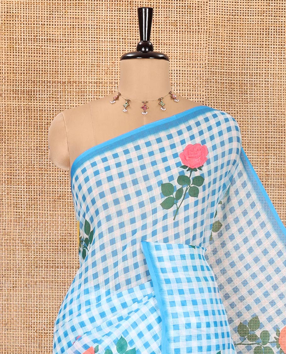 Borderless blue linen Cotton Saree, Graced with Rose Floral Buttas and Checked Design on Its Body, Pallu Pictures a Beautiful Rose Floral Motifs, and Paired with a Matching Blouse