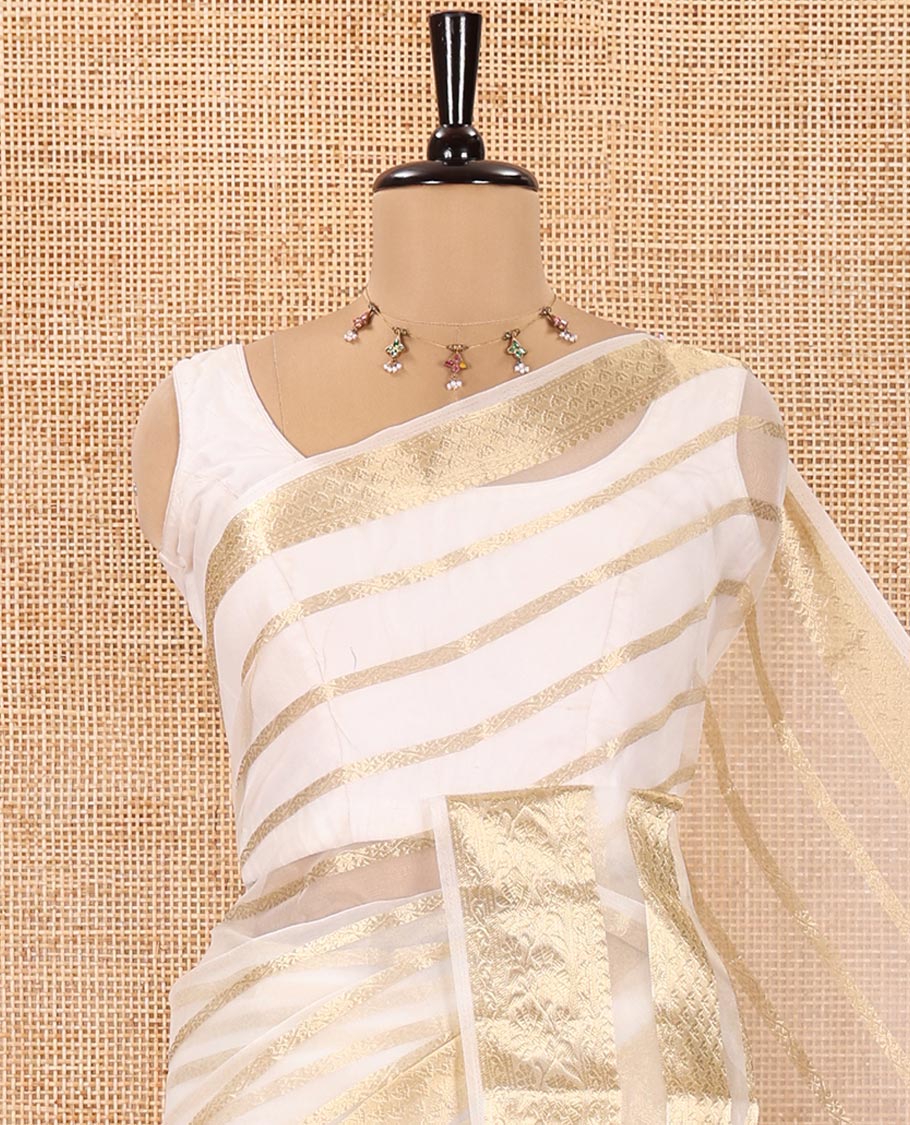 Cream Semi-Organza Saree, Steeped in Richness of Horizontal Zari Stripes All Over Its Body, Highlighted by a Traditional Zari Design Border, Gleaming Zari Design Pallu, and Paired with a Matching Blouse