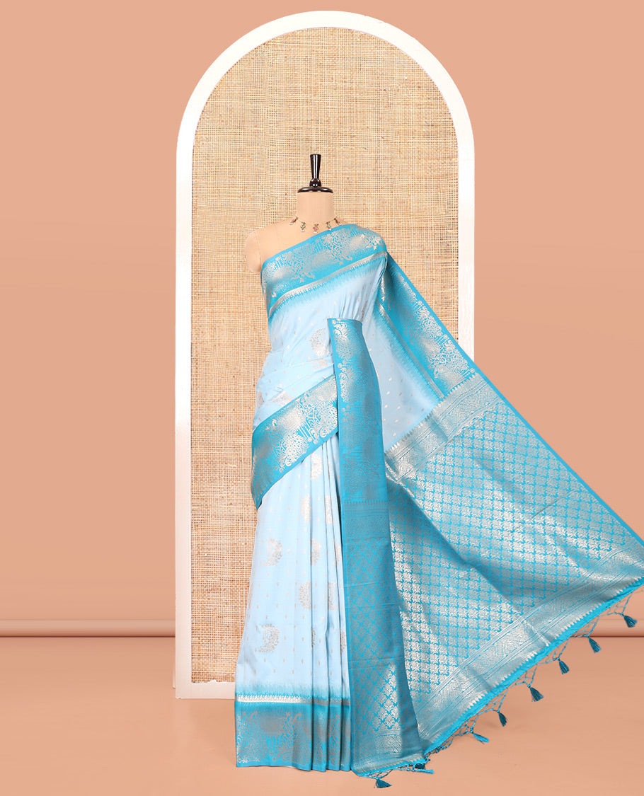 Sky Blue Elite Soft Silk Saree, Showcasing Zari Buttas on Its Body, Complemented by a Contrast Peacock-Floral Zari Blouse, Intricately Designed Pallu, and Paired with a Contrast Blouse