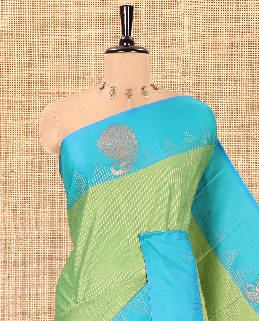 Parrot Green Kanchi Soft Silk Saree, Majestically Detailed with Vaira Oosi, and Zari Buttas All Over Its Body, Complemented by Contrast Border of Paisleys, an Intricately Designed Pallu, and Paired with a Contrast Blouse