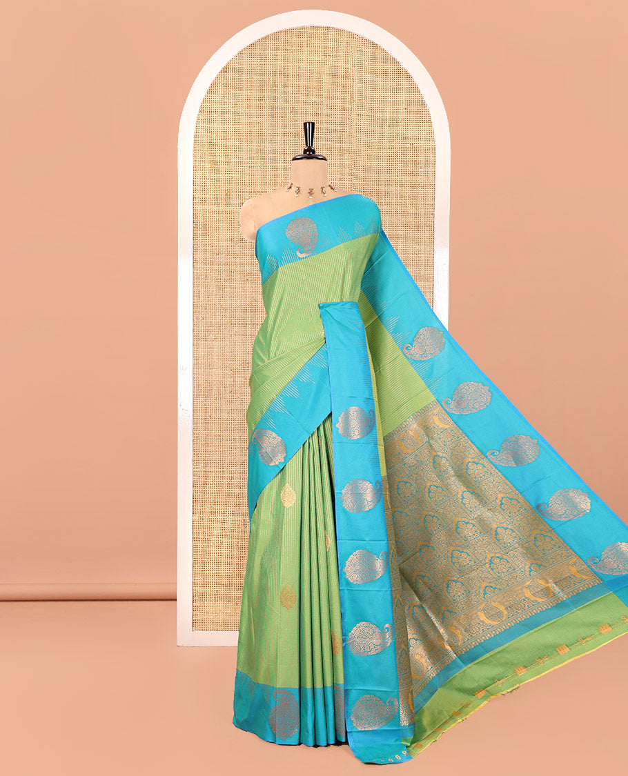 Parrot Green Kanchi Soft Silk Saree, Majestically Detailed with Vaira Oosi, and Zari Buttas All Over Its Body, Complemented by Contrast Border of Paisleys, an Intricately Designed Pallu, and Paired with a Contrast Blouse