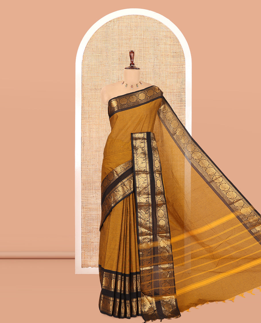 Mustard Plain Chettinad Cotton Saree, Complemented by a Contrast Peacock-Chakram Rettai Pettu Border, and a Matching Blouse