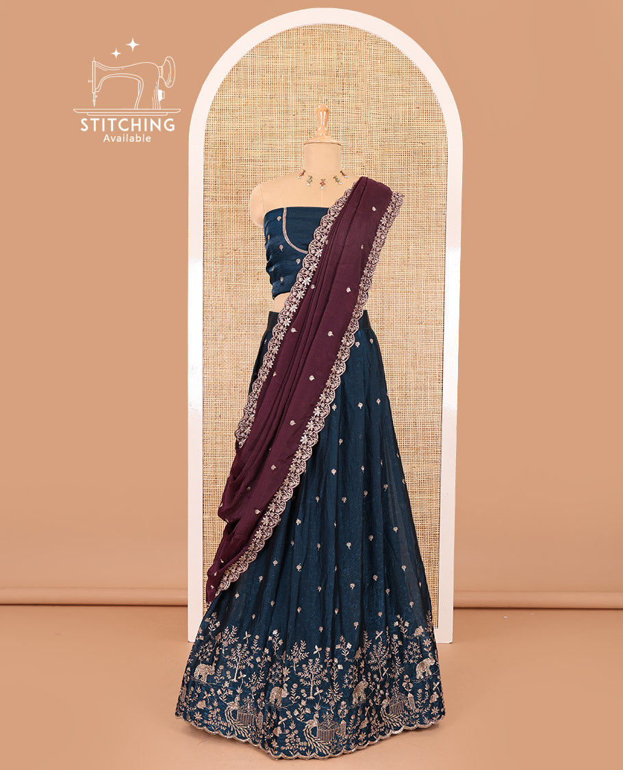 Peacock blue half-saree, buttas and flora-fauna embroidered bordered velvet organza skirt, a matching velvet organza blouse, and a contrast embroidered scallop syska georgette dhavanif