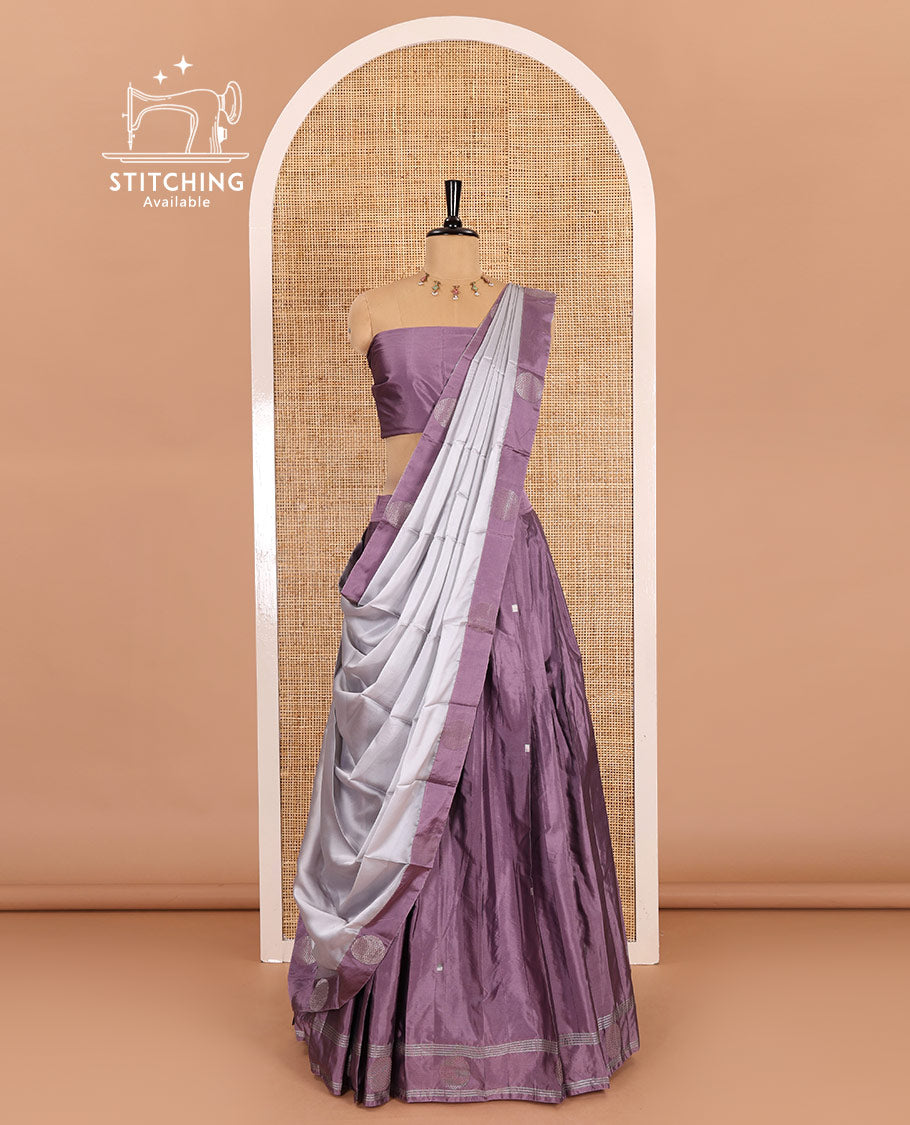 Light voilet half-saree, buttas with self-bordered taffeta silk skirt, a plain blouse, and a contrast round butta bordered satin georgette dhavani