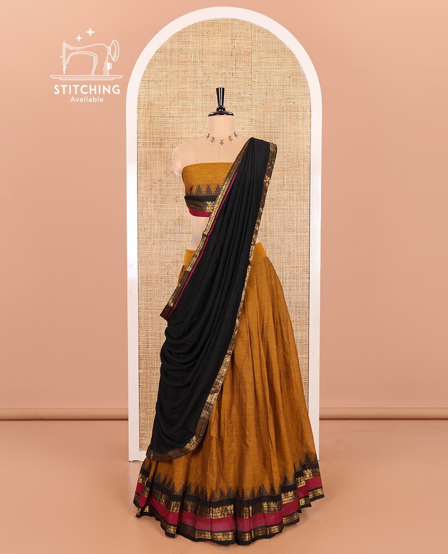 Mustard and Black Chettinad Cotton Half-Saree Featuring a Plain Skirt, Highlighted with a Contrast Traditional Zari Rettai Pettu Temple Border, a Subtly Woven Matching Blouse, and a Vichitra Silk Contrast Traditional Zari-Bordered Dhavani