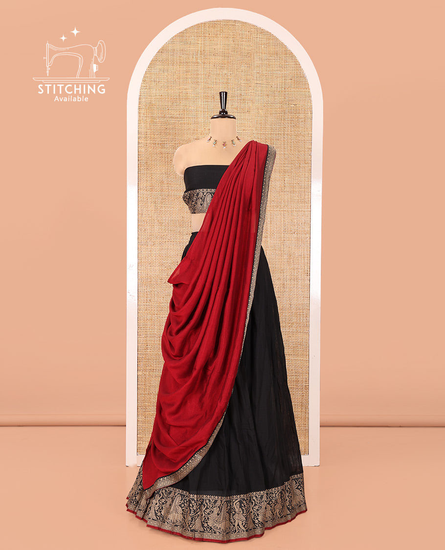 Black Mercerised Cotton Half-Saree Set, Plain with Dancing Figurines Woven Bordered Skirt, Paired With a Matching Blouse, and Comes with a Contrast Dhavani