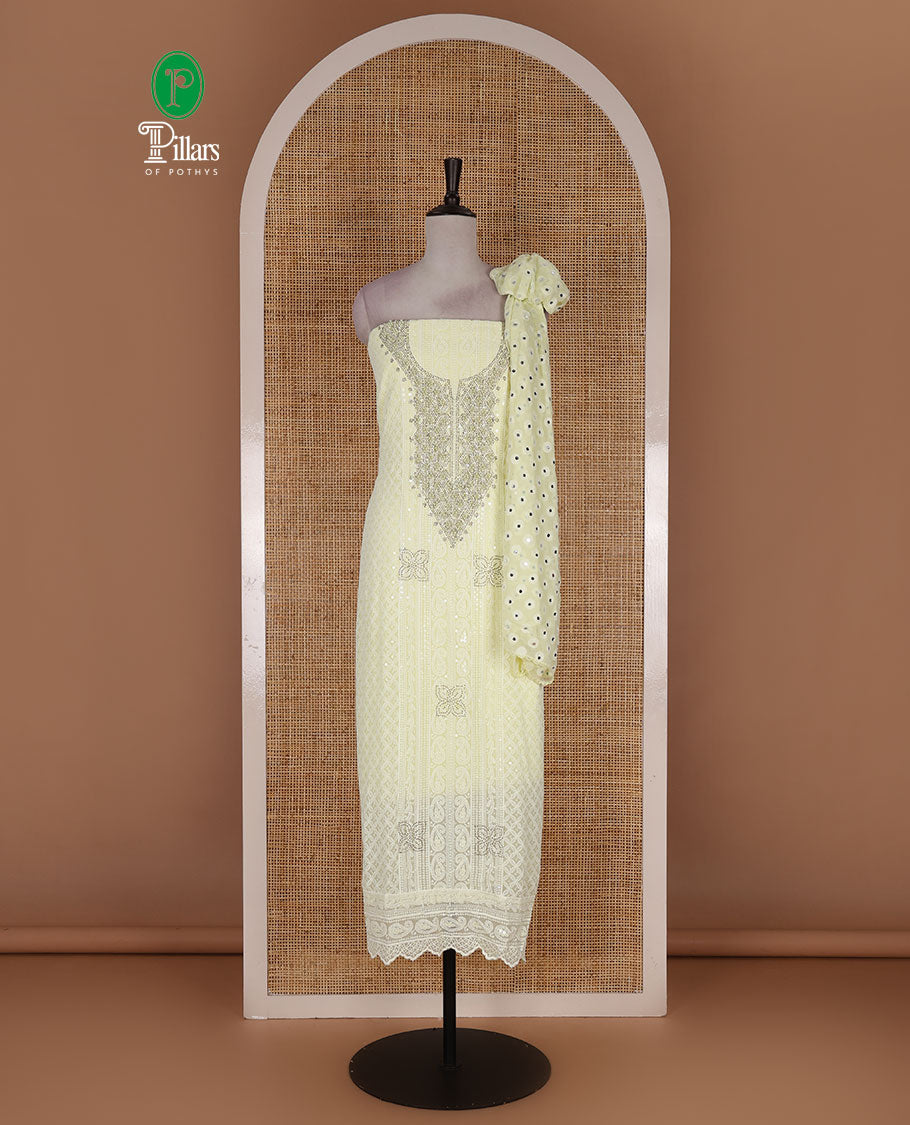 Lime yellow material churidar set, stone work with Schiffli style embroidered georgette top, American Crape bottom, and polka dotted printed mirror work dupatta
