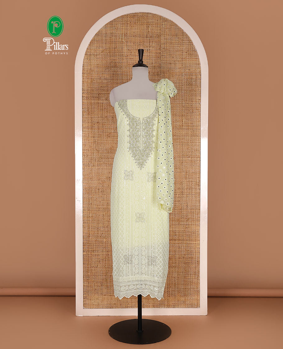 Lime yellow material churidar set, stone work with Schiffli style embroidered georgette top, American Crape bottom, and polka dotted printed mirror work dupatta