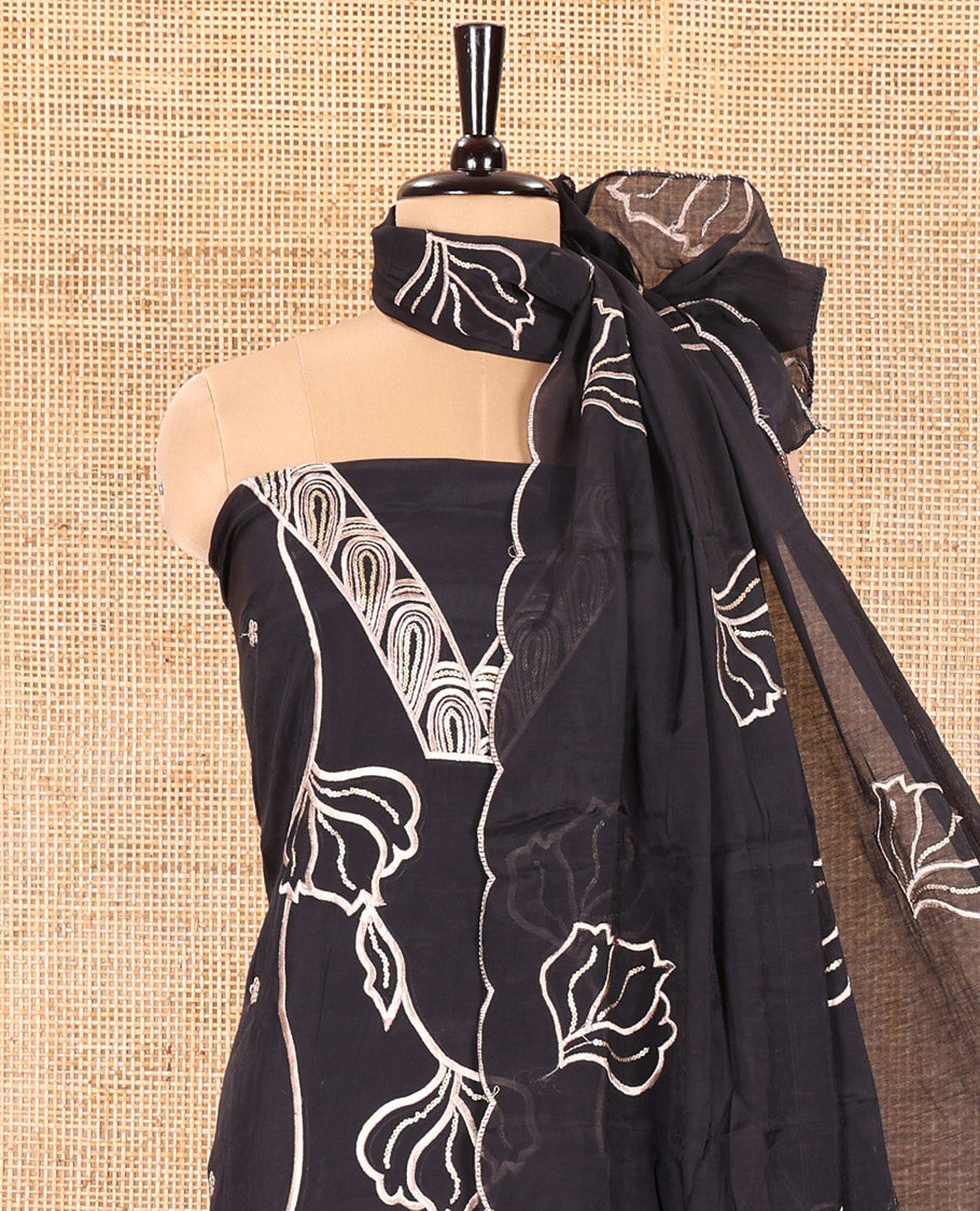 Black Mul Chanderi Material Churidar Set, Spotlighted with Flower Embroidery and Sequins Work V-Neck Top, a Plain Santoon Bottom, and Paired with a Mul Chanderi Floral Embroidered Dupatta