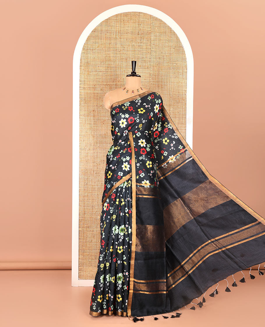 Black colorful floral printed banana pith saree, piping zari border, zari decked pallu, and a contrast floral printed blouse
