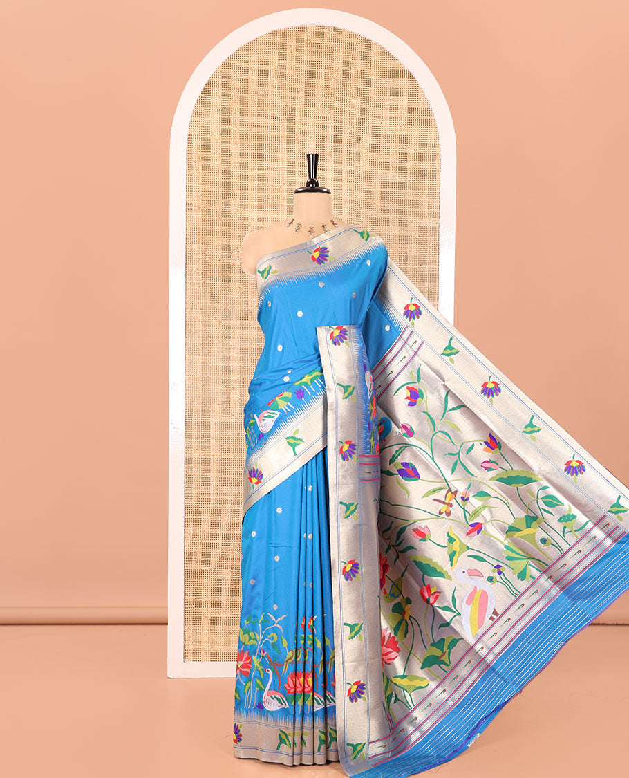 Blue Paithani Art Silk Saree, Accentuated with Flower Buttas All Over Its Body, Highlighted by Zari Temple Border Pictures Colorful Flora-Fauna Designs, Pallu Depicts Colorful Floral and Bird Designs, and Paired with a Matching Blouse