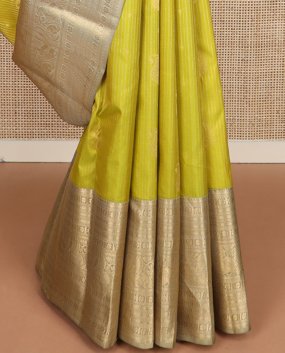 Yellow zari design silk saree, contrast border of rekku, banaras, kamalam, neli, and mayil designs, and intricate pallu