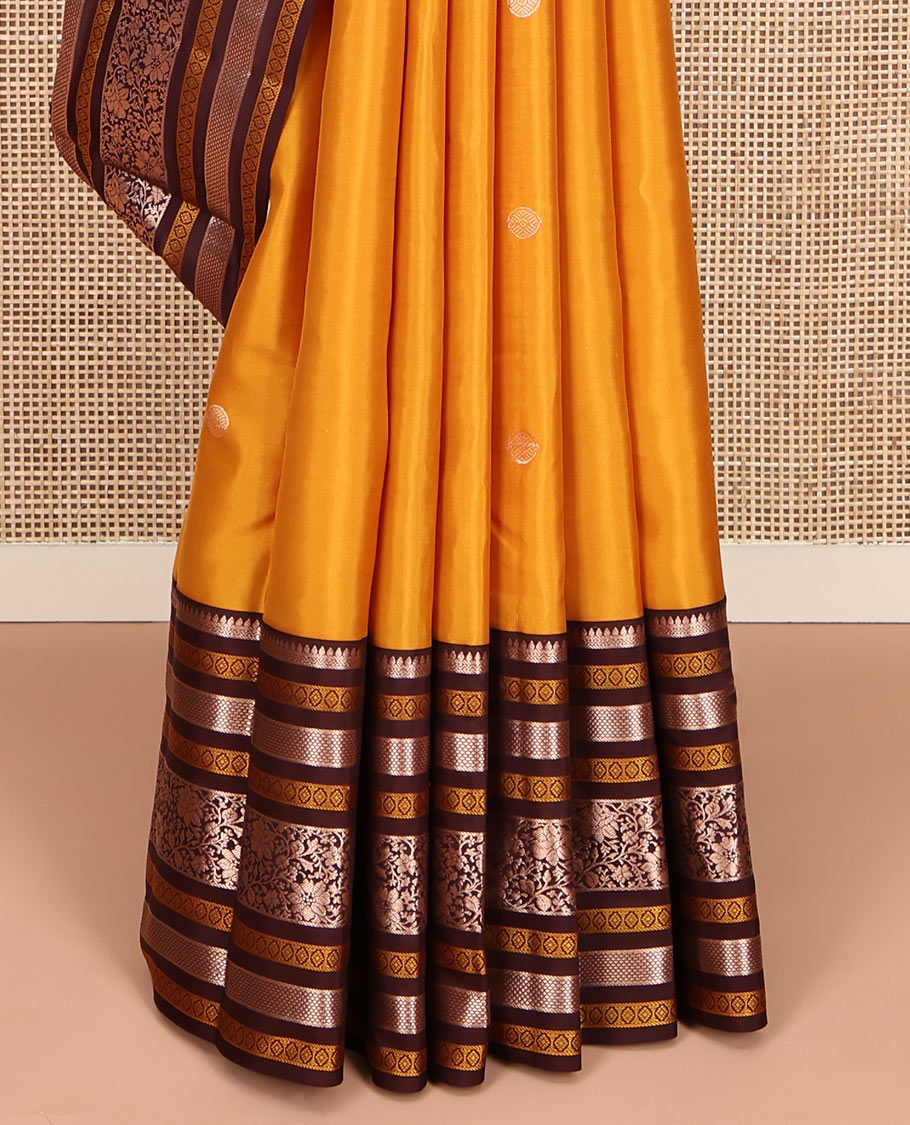 Yellow Vasundhara Silk Saree, Richly Detailed with Zari Buttas All Over Its Body, Complemented by a Contrast Border of Thilakam, Neli, Laddu Kamalam, and Kodi Visiry Designs, Pallu of Butta Enclosed Checks, and Paired with a Contrast Blouse