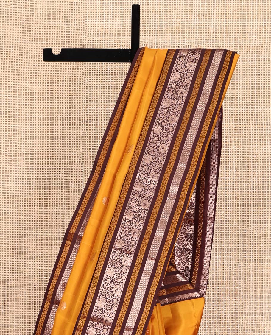 Yellow Vasundhara Silk Saree, Richly Detailed with Zari Buttas All Over Its Body, Complemented by a Contrast Border of Thilakam, Neli, Laddu Kamalam, and Kodi Visiry Designs, Pallu of Butta Enclosed Checks, and Paired with a Contrast Blouse