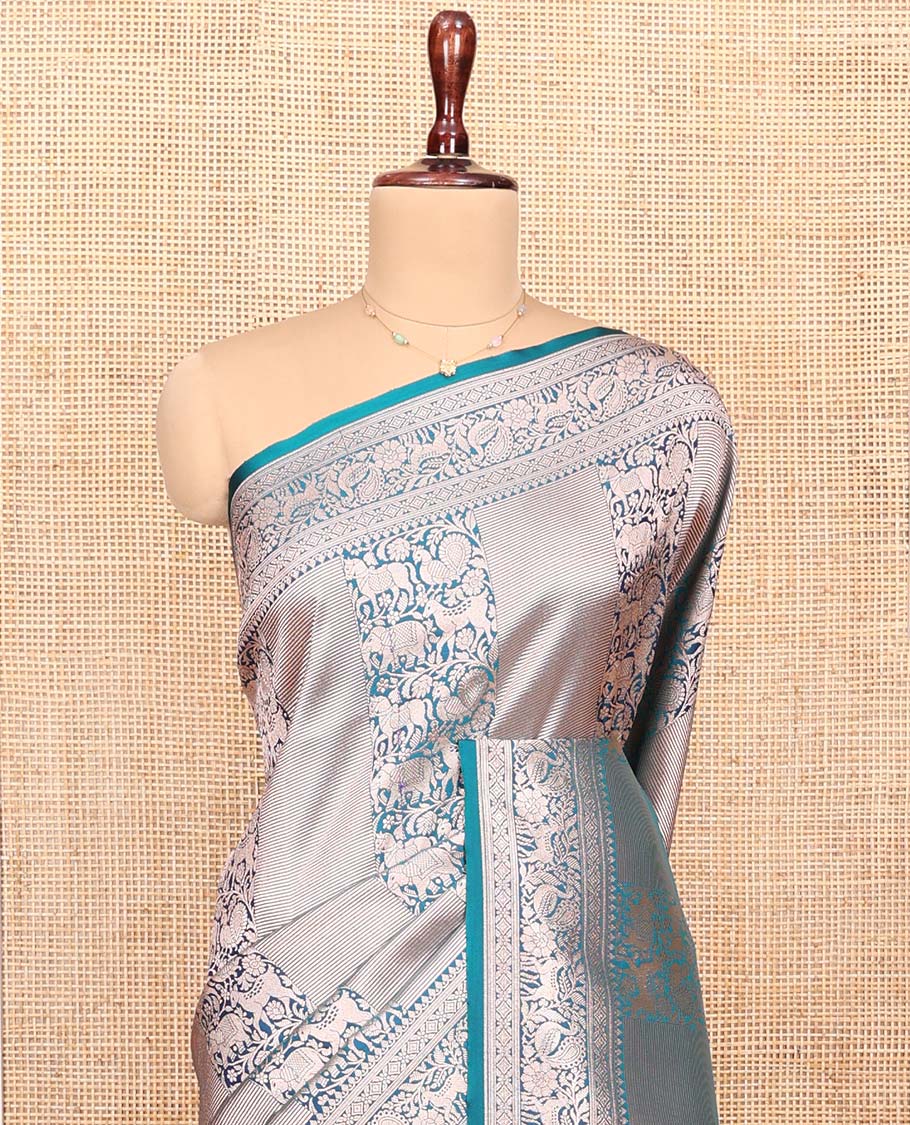 Blue Semi-Banaras Silk Saree, Opulently Embellished with Animal-themed Jacquard Designs on Its Body, Highlighted by a Zari Border of Traditional Designs, Pallu Steeped with Stripes, and Paired with a Matching Blouse