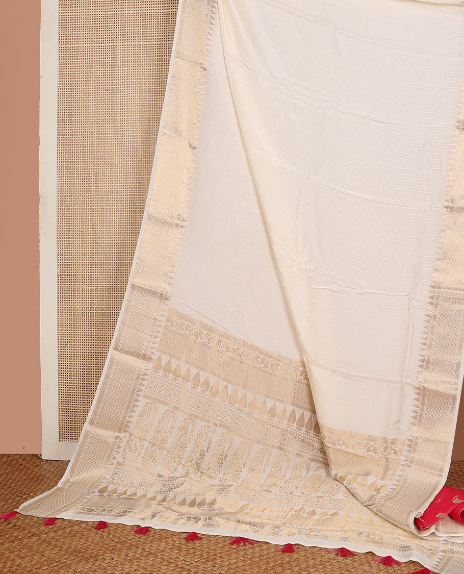 Dazzling white sparsely checked silk saree, traditional zari border, and traditional pallu of paisleys