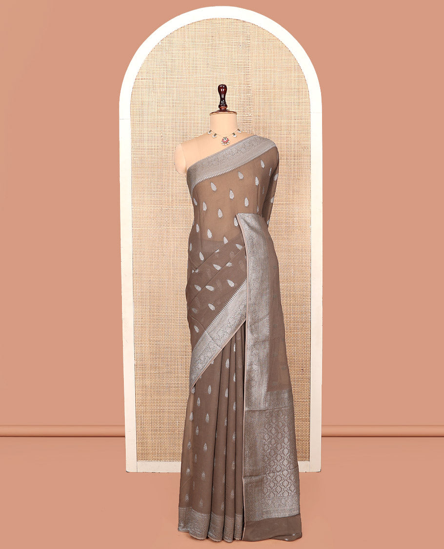 Brown Georgette Saree, Steeped with Buttas, Highlighted by a Traditional Floral Creeper Border, Intricately Designed Pallu, and a Matching Blouse