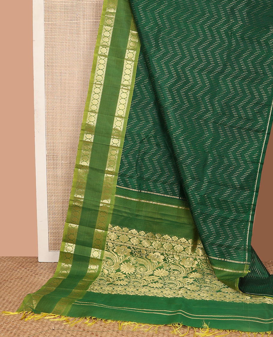 Green zari buttas Kanchipuram silk saree, contrast rettai pettu one-sided border of rekku, banaras, and chakram designs, and floral design pallu