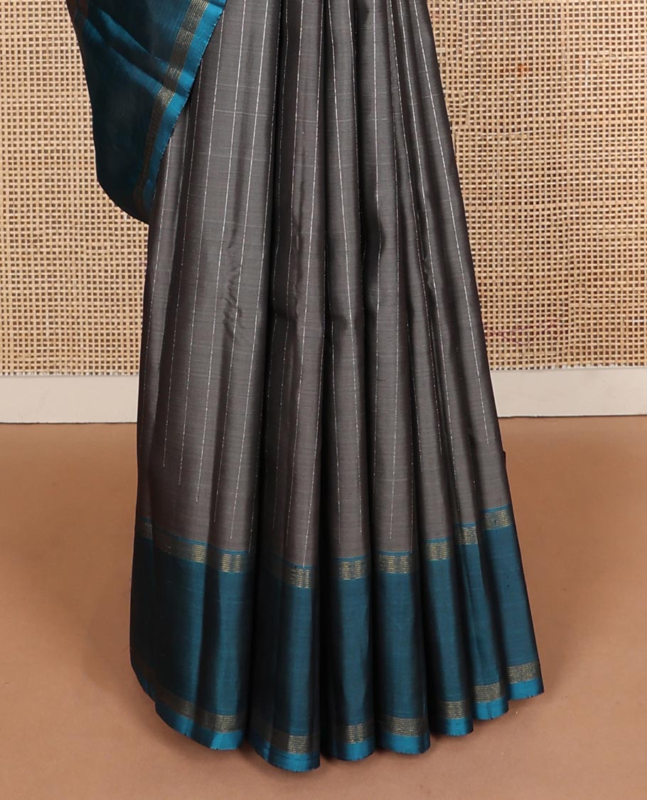 Dark grey striped Kanchipuram silk saree, contrast rettai pettu striped border, and temple zari pallu