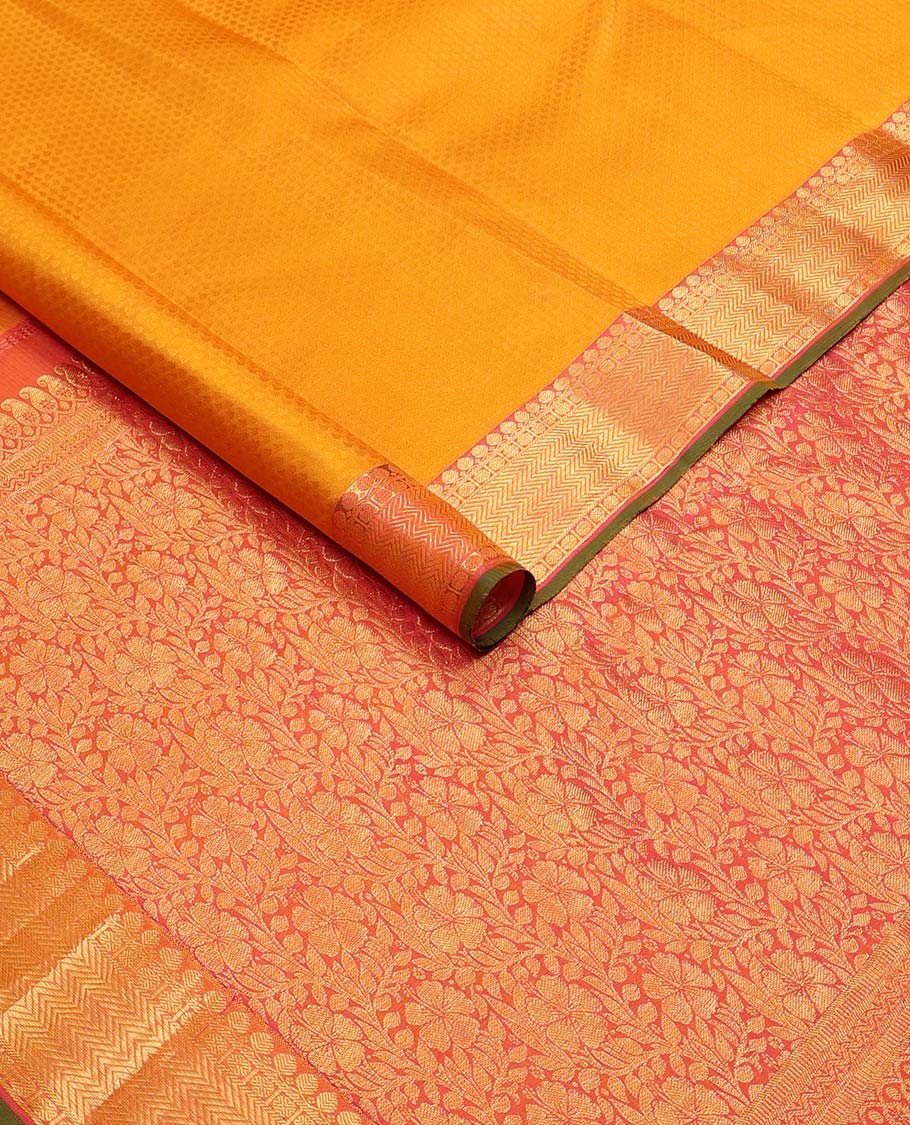 Orange floral design silk saree with contrast border of thilakam mokku, paun, vanki design & floral pallu