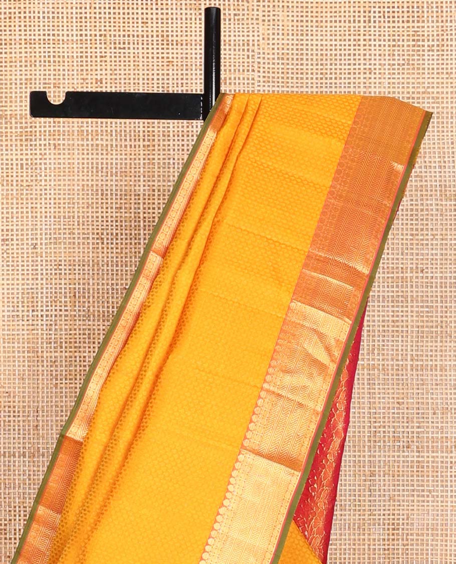 Orange floral design silk saree with contrast border of thilakam mokku, paun, vanki design & floral pallu