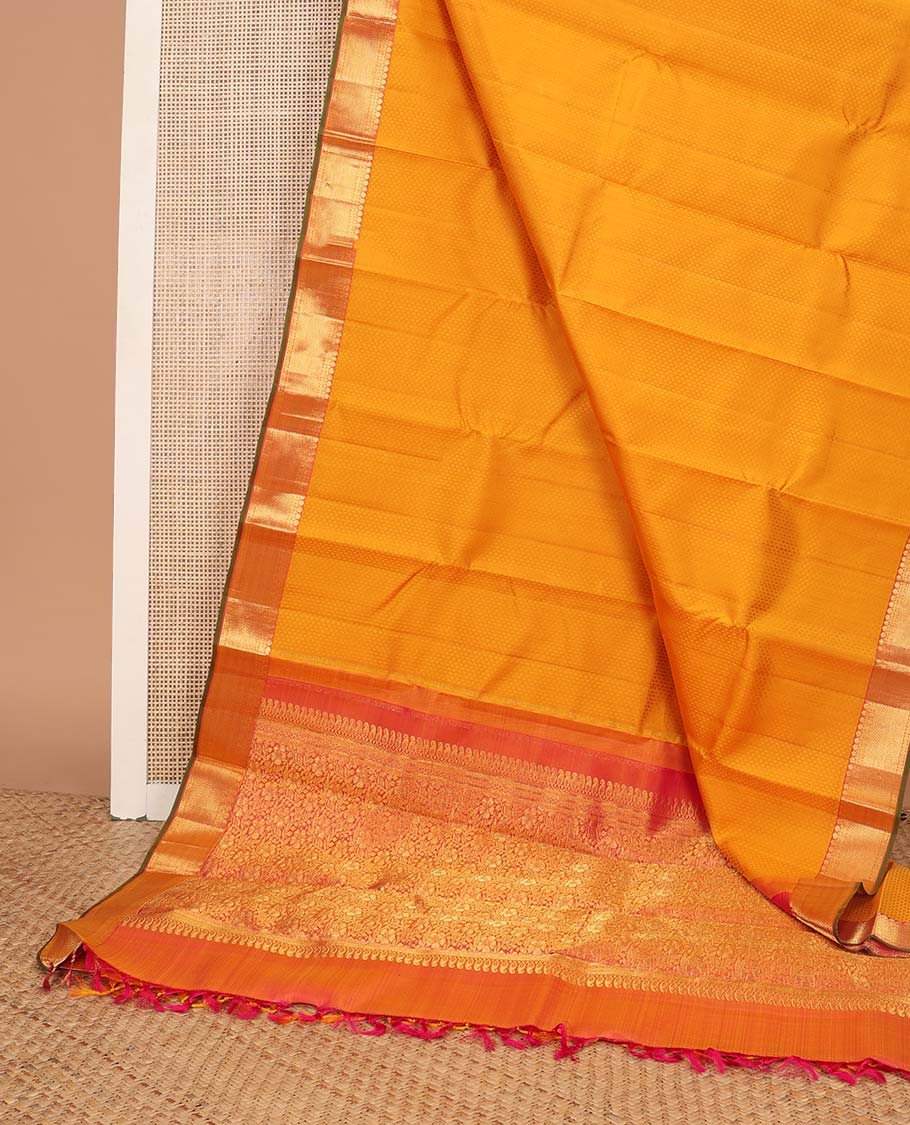 Orange floral design silk saree with contrast border of thilakam mokku, paun, vanki design & floral pallu