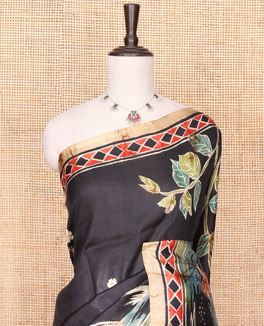 Black Printed Silk Saree Adorned with Colorful Floral Motifs Printed All Across Its Body, Highlighted with a Contrast Geometric Printed Border, Pallu Depicting the Darwing of Goddess Durga Killing Mahishasura, and Attached with a Printed Blouse