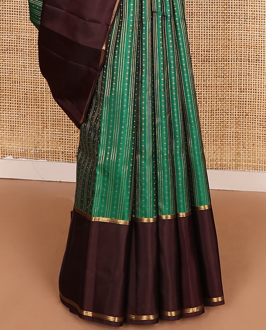 Green Vasundhara Lite-Silk Mix Saree Features Zari Stripes, Complemented with a Contrast Rettai Pettu Neli Striped Border, a Majestically Detailed Pallu with Jaal Designs, and a Contrast Blouse