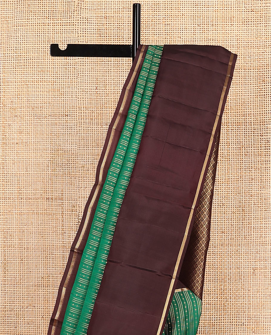 Green Vasundhara Lite-Silk Mix Saree Features Zari Stripes, Complemented with a Contrast Rettai Pettu Neli Striped Border, a Majestically Detailed Pallu with Jaal Designs, and a Contrast Blouse