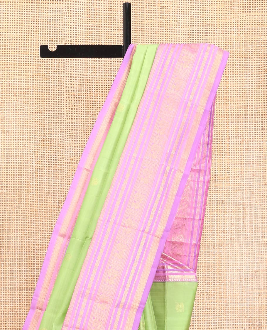 Green Vasundhara Silk Saree, Accentuated with Mayil and Chakram Buttas All Over Its Body, Complemented by a Contrast Border of Rekku, Muthu, Kathir, Poun, Mayil and Mayil Kann Designs, Grand Pallu, and Paired with a Contrast Blouse