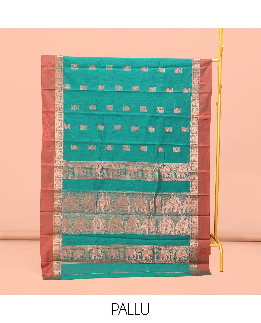 Green Semi-Silk Cotton Saree, Impeccably Styled with Buttas All Over Its Body, Complemented by a Contrast Peacock Design Kal Eragina Border, Pallu Steeped with Elephant Design, and Paired with a Matching Blouse