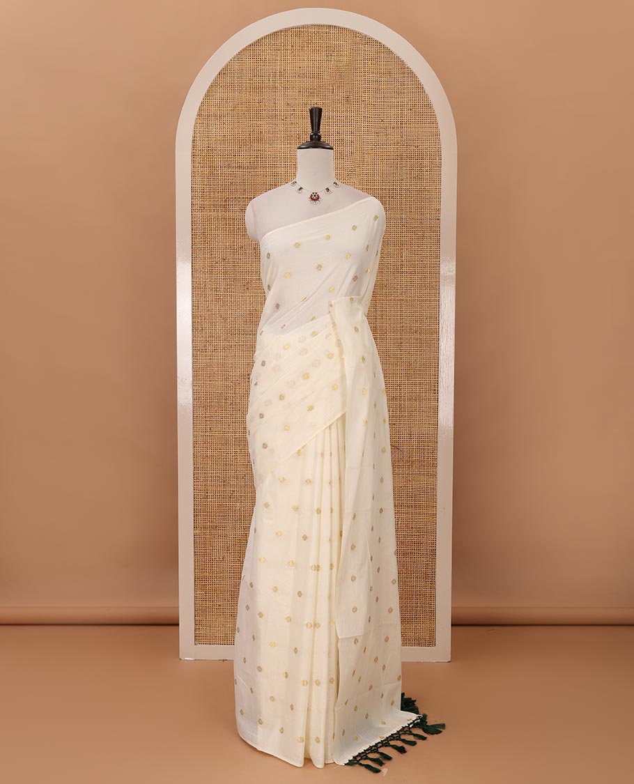 Borderless Kerala cream all over zari buttas saree, zari design pallu with green tussels & zari buttas blouse