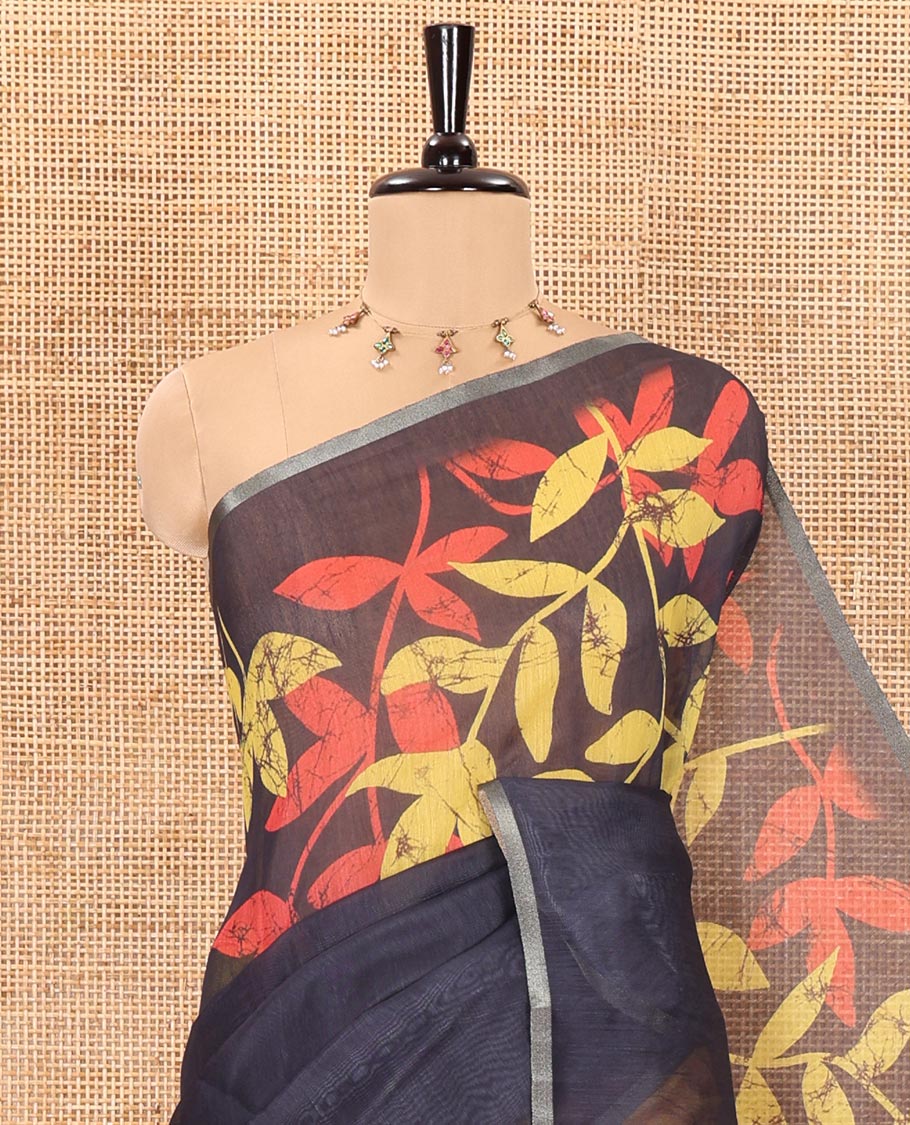 Yellow and black batik print and leaf vine printed linen saree, zari piping border, printed pallu, and a contrast batik printed blouse